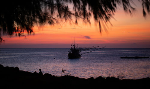 Silhouette sailboats in sea against sky during sunset