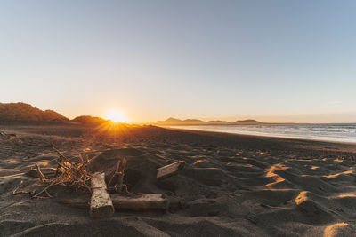 Scenic view of sea against clear sky during sunset