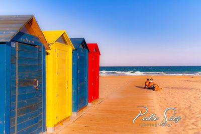 Scenic view of beach against clear blue sky