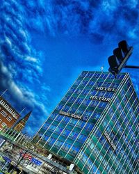 Low angle view of modern building against cloudy sky