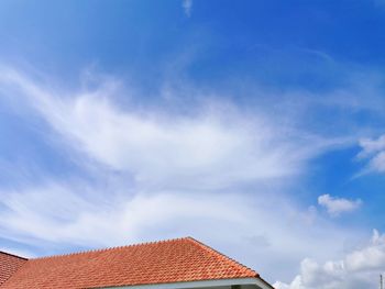 Low angle view of building against cloudy sky