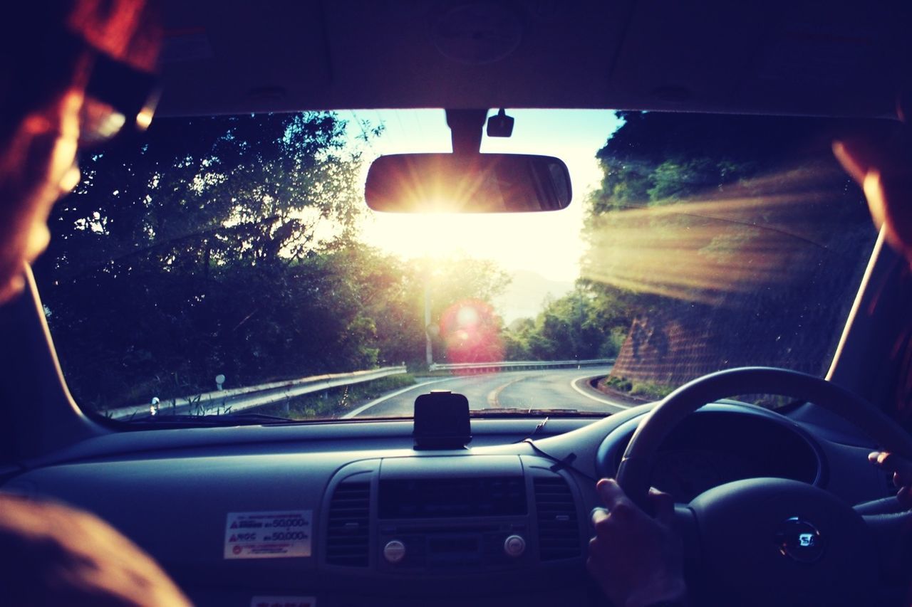 transportation, mode of transport, land vehicle, car, vehicle interior, car interior, windshield, travel, sun, part of, on the move, lens flare, side-view mirror, sunbeam, driving, journey, dashboard, cropped, steering wheel, vehicle seat