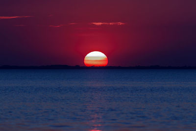 Scenic view of sea against romantic sky at sunset