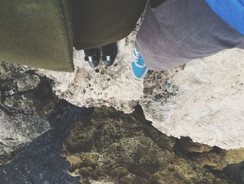 Low section of people standing on rock