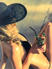 Close-up of woman with drink on beach