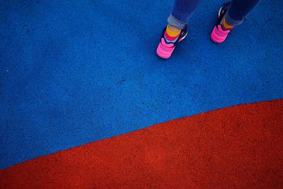 Low section of child standing on sports court