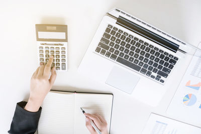 Low section of person using laptop on table