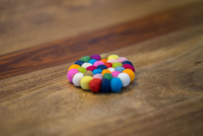 High angle view of multi colored balls on wooden table
