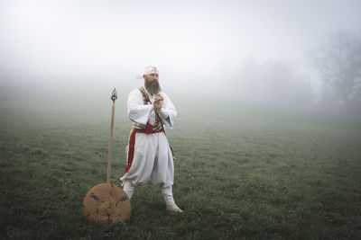 Full length of man standing on field