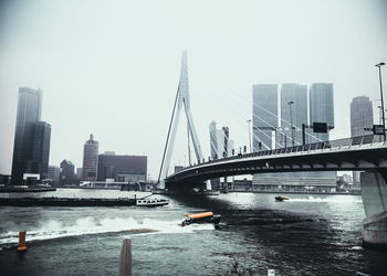 View of suspension bridge with city in background
