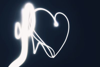 Close-up of illuminated heart shape against black background