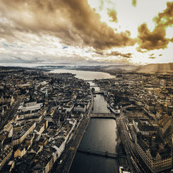 Aerial view of city against cloudy sky