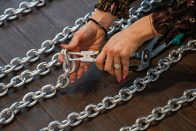 Close-up of hand holding chain