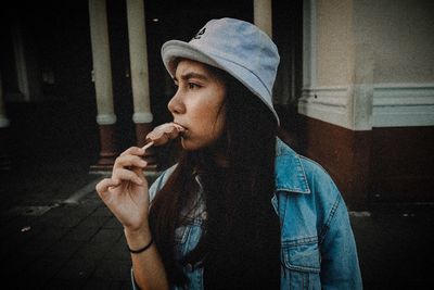 Portrait of young man smoking cigarette