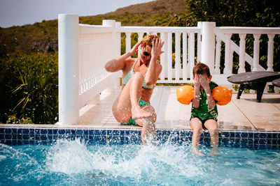 Mother and son playing in swimming pool