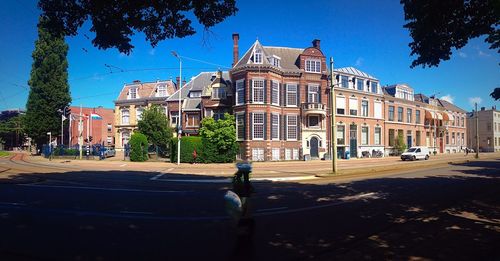 Buildings in city against blue sky