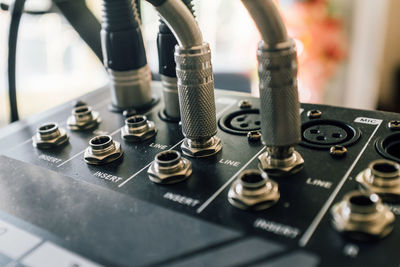 Close-up of jacks connected to sound mixer in recording studio