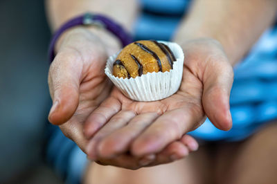 Woman hands giving sweet cake with chocolate, closeup