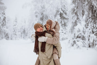 Couple in love walks in the winter forest