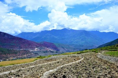 Scenic view of landscape and mountains against sky