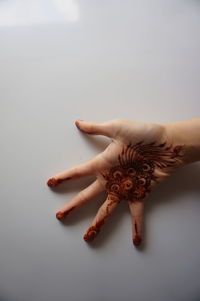 Close-up of woman hand over white background