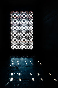 Low angle view of illuminated falling through window in building