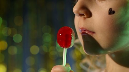 Close-up of girl eating lollipop