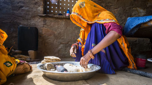 Full length of woman preparing meal in kitchen