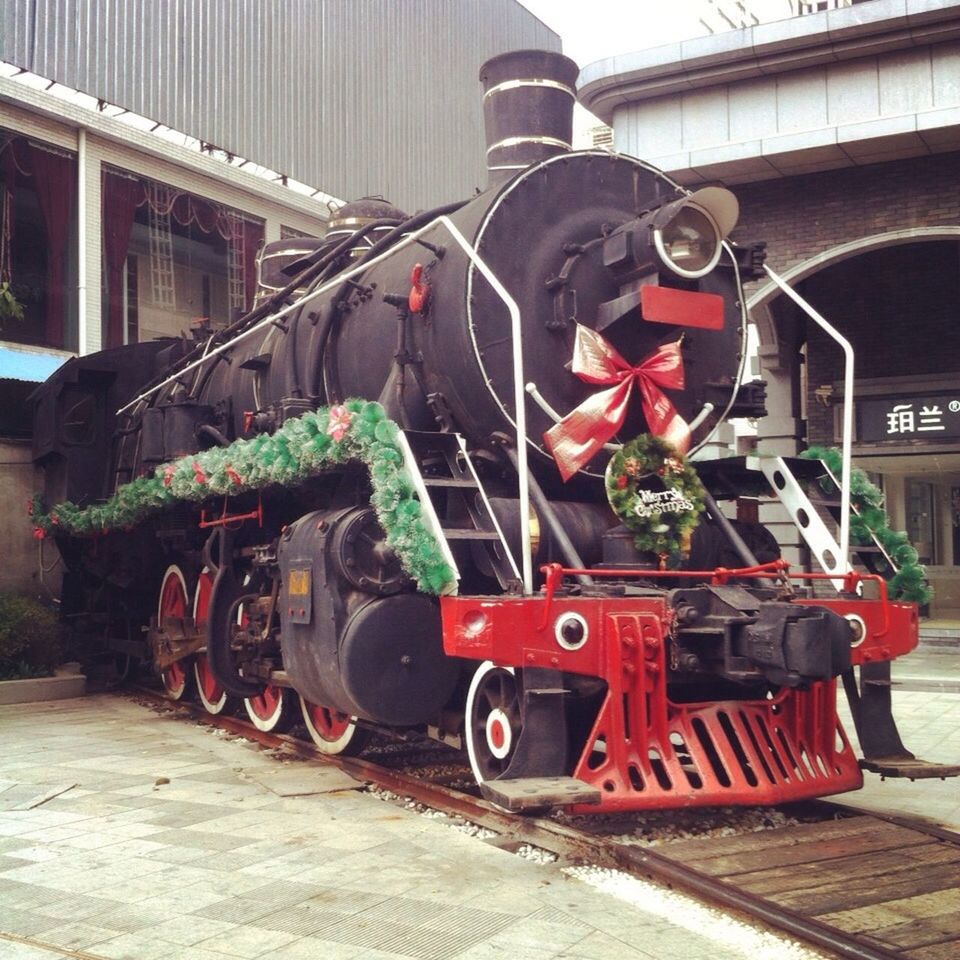 transportation, red, mode of transport, land vehicle, stationary, day, built structure, outdoors, no people, car, plant, parking, building exterior, street, metal, architecture, old-fashioned, parked, wheel, railroad track