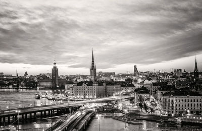 Cityscape against cloudy sky