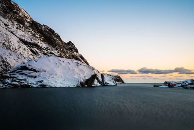 Scenic view of sea against clear sky during sunset