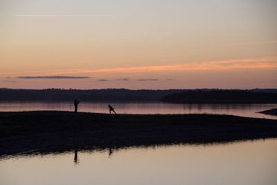 Scenic view of lake at sunset