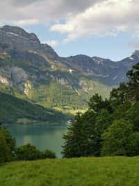 Scenic view of lake and mountains against sky