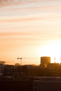 High angle view of silhouette buildings against sky during sunset