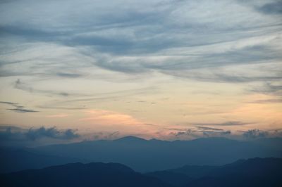 Scenic view of silhouette mountains against sky at sunset