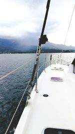 Close-up of snow on lake against sky