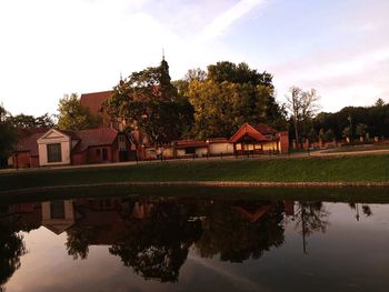 Reflection of trees and buildings on lake