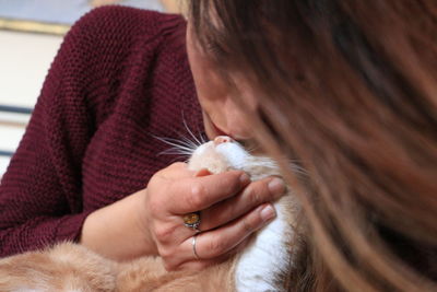 Close-up of woman kissing cat