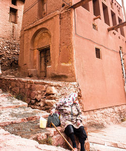 Man sitting on old building