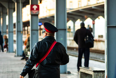 Rear view of man standing in city