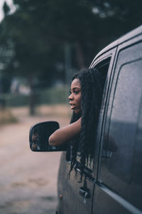 Nice african woman in car window.