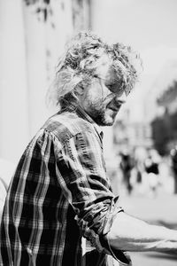 Side view of young man in city