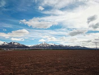 Scenic view of mountains against cloudy sky