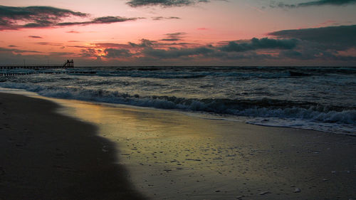 Scenic view of beach against sky during sunset