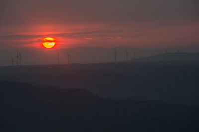 Scenic view of mountains against orange sky