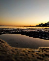 Scenic view of sea against clear sky during sunset