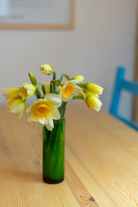 Close-up of yellow flower vase on table