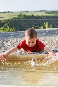 Cheerful boy enjoying in water