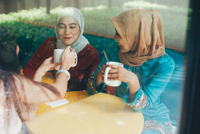 Couple holding drink in restaurant