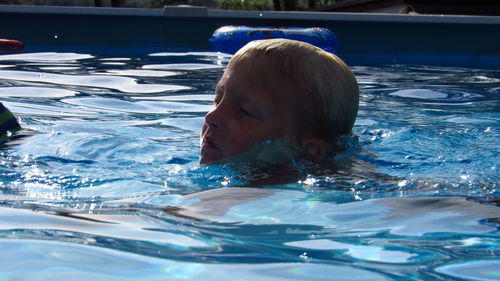 Portrait of boy swimming in pool